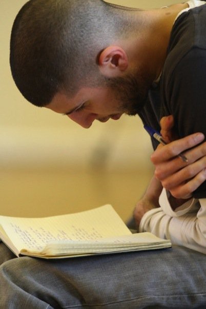 A man writing poems, "Taken at the Royal Shakespeare Company."