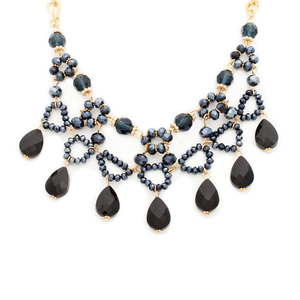 It features of sleek black teardrop beads on a gold chain. Unique in every way, this statement necklace is a jewelry box must-have. 