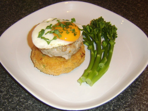 100% pork burger on a breaded potato cake with fried egg and tenderstem broccoli