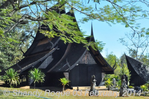 Statues of Garudas welcome you at the entrance of this small, dark house.