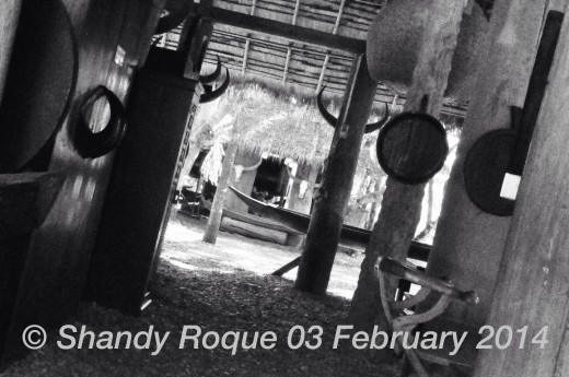 The covered area outside the main house is filled with chairs, wardrobes and pillars decorated with more skulls.