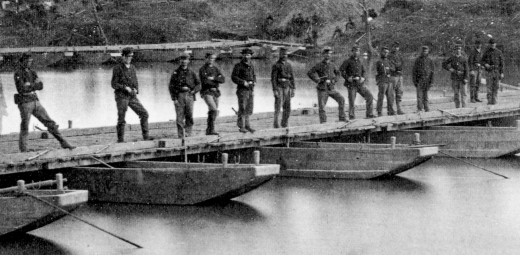 Engineers stand on the pontoon bridge they constructed