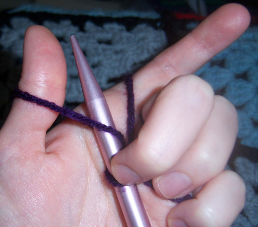 It was rather hard to do this one handed, but my middle finger is holding the yarn on the needle in place. This is how you slip the needle under the yarn from your thumb.