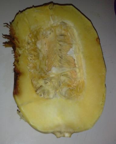 Step 2. Cut in half and remove insides. This is what it looks like cut in half. Remove inside pulp and seeds the way you would a cantaloupe or melon. FYI: The brown discoloration is where it rest on the baking pan while cooking.