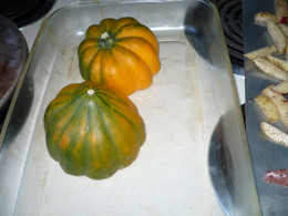 Acorn squash cut in half and put face down on the glass oven dish.