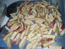 Fries washed, cut and balsamic / oil has been added ready for the oven.