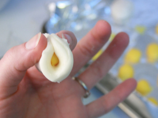 Make the yolk balls and add the white flattened round piece to wrap it up
