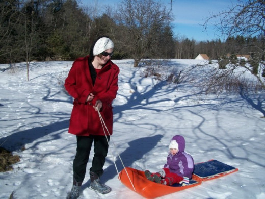 Here is a picture of the famous toboggan used throughout my childhood. I am pulling my daughter around the farm. Excuse my strange appearance, I was not expecting on going out that day. 