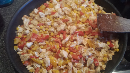 The seasoned chicken with the peppers and the sweetcorn