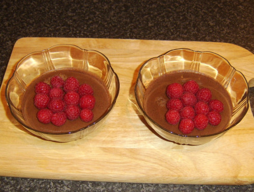 Raspberries are arranged on set coffee and ginger jelly
