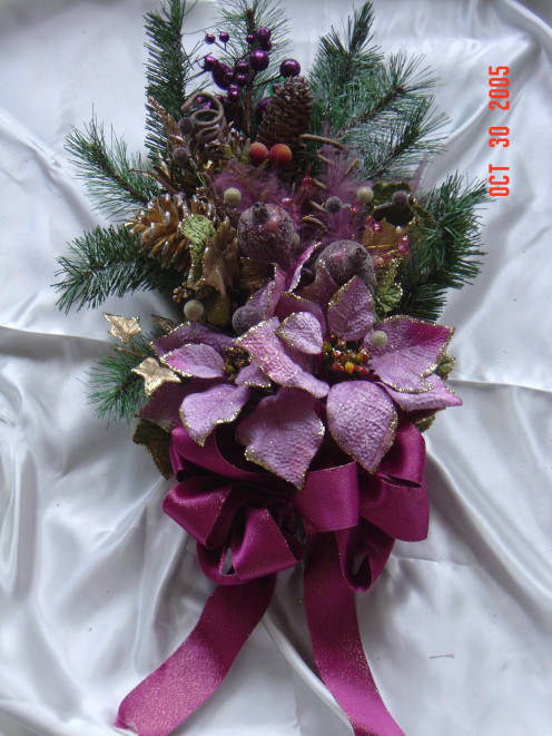 Evergreen Handmade Swag. made out of real pine and artifical poinsettias and ribbon. This homemade swag would look great on a door or any place that you want to hang a Christmas decoration in your home.