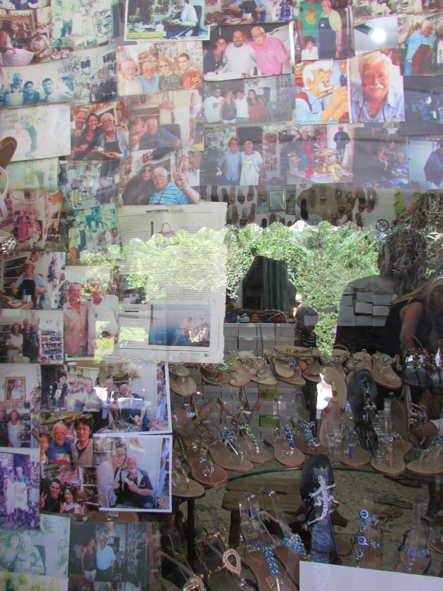 Antonio Viva's shop window, displaying many photos of the man himself with his happy customers.