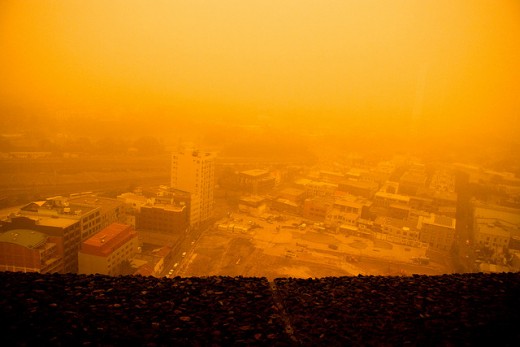 Red dust and smog seen from a rooftop.