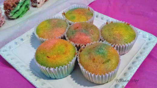 To achieve one layer of each color more evenly, pipe batter into cupcake liner using a piping bag.  I used a spoon for these instead, letting the colors swirl and mix with each other.
