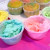 Separate Icing into small bowls and drop separate colors of the food coloring into each bowl.  Start with one drop at a time to achieve the color you want.