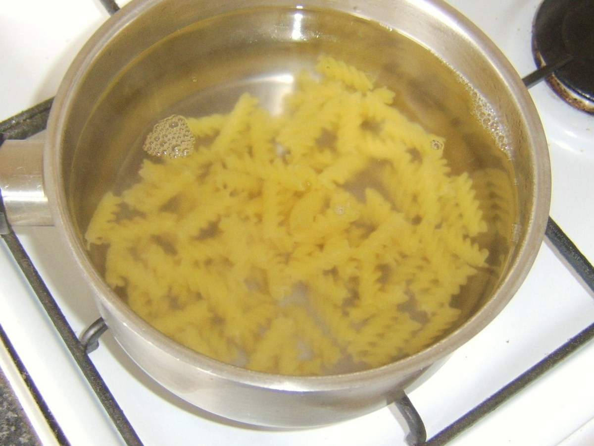 Fusilli pasta is added to boiling, salted water