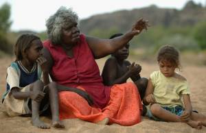 An Aborigine woman telling children stories 