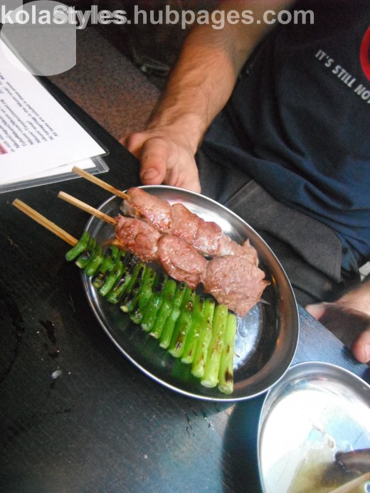 Grilled offal and garlic shoots