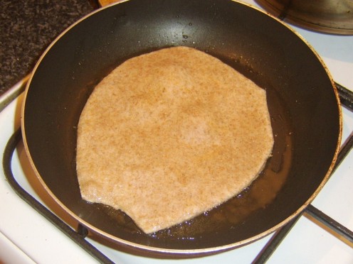 Paratha is fried in a hot frying pan