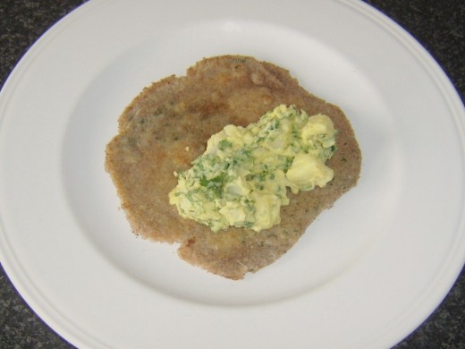 Spicy potato salad is added to coriander and garlic paratha