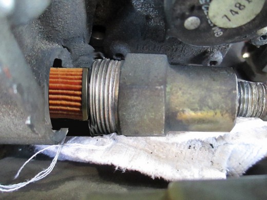 ...when the nut is unscrewed from the carburetor the filter will be right there.