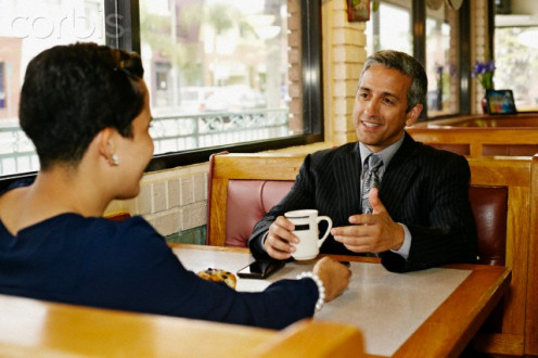 The man with the cup of coffee has an embarrassing eating problem and chose to meet his client one-on-one and just drink coffee as to not lose the client's business.