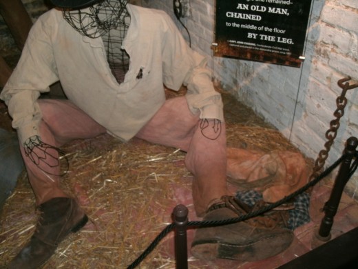 Freedom House slave, wearing rags and in leg irons