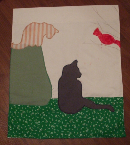 This custom flag features my 2 cats and a cardinal.