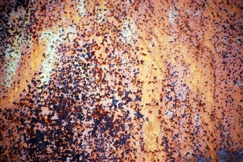 A picture of corroding metal. It shows metal surface that undergoes corrosion. 