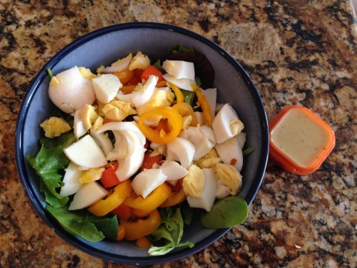 Salad with hard boiled eggs and a side of homemade dijon vinaigrette