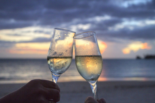 Honeymoon image of two glasses. make reservations early and enjoy discounts