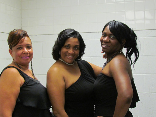 Backup dancers for The Songbird, Sheila Coley prepare to go on stage for their show.