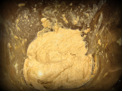 This hummus is almost done!  Take a quick taste test.  If the texture and flavor is right, scoop out into a bowl and enjoy!  This picture is about after 2 minutes.  It needed a bit more olive oil and another minute until it was ready. 