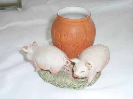 Boston Baked Beans. The Boston Baked Bean with 2 pigs in a little more rare. The one shown below with the green pot was featured in the book "This little Piggy"  while this one was not. 3" x 2 1/4" Paid $28. Rare
