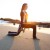 Kiana Tom working out with barbells on a beach at sunset in black and white long sleeves and long pants in Kiana Tom working out with barbells on a beach at sunset in black and white long sleeves and long pants in