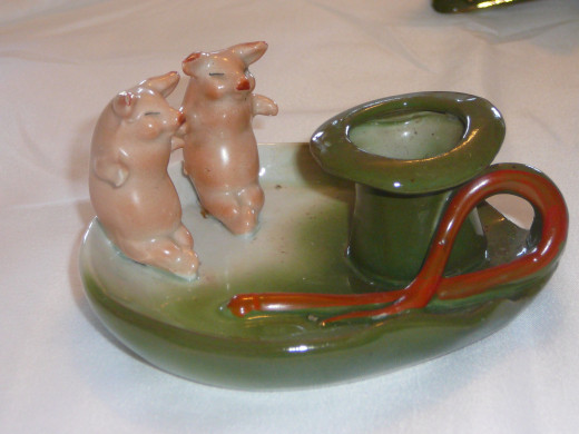 This candlestick is much more common. Featured in "This little Piggy" its '92 value ranged between $80-90 depending on the patina.$ 4 1/2" x 2 1/4". Paid $32. Common