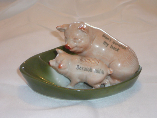 It's hard to say if this is an ashtray or a match holder. The adult pig reads "Don't scratch my back" and the baby's reads "Scratch mine". You can see the ridges where you are able to strike the match.  $5 1/2" x 2 1/2". Paid 47. Rare