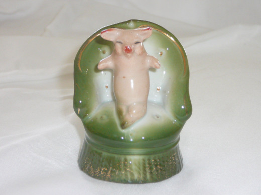 This is a lovely example of a pig seated in a vanity chair. She looks ready to put on her makeup. Featured in "This little Piggy" its value in '92 was $170. 3 3/4" 3 1/2". Paid $65. Rare.