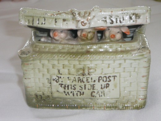 3 little pigs in a basket. "Parcel Post This Side Up With Care". Featured in "This little Piggy" its '92 price was $120. 4" x 3 1/4" Paid $23. Rare