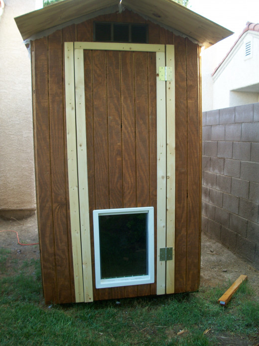 After front siding is installed and door assembly is complete, vertical trim was installed for mounting the hinges.