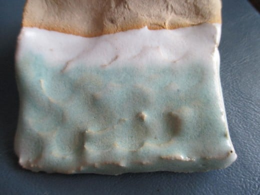 This was from another student in my Ceramics 101 class. This student was smart enough to glaze with white, then celadon. The grey clay can be dark enough to show through the celadon otherwise --- as in the ugly piece, below.