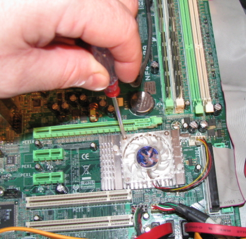 Removing the screws that secure the fan to the North Bridge heatsink. Removing the screws that secure the fan to the North Bridge heatsink.