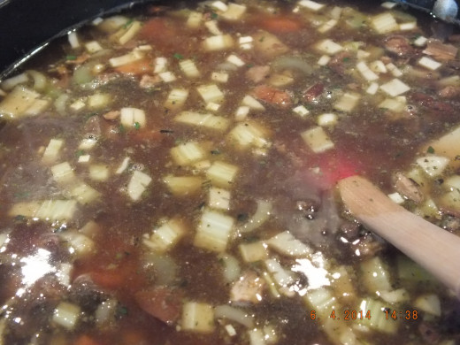 Add your mushroom and vegetable broth, bring to a boil, then lower the temperature.
