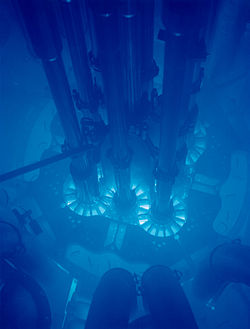Cherenkov radiation is emitted when charged subatomic particles are moving faster than light within a material.