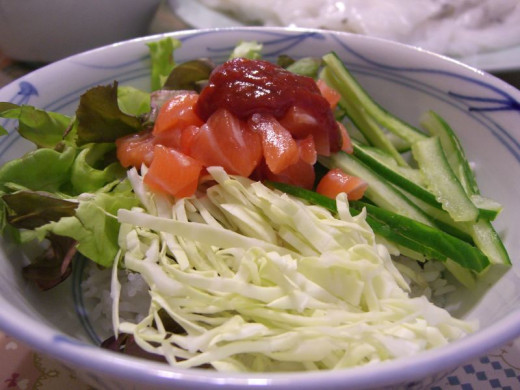 Cubed raw fish mixed with fresh vegetables and rice