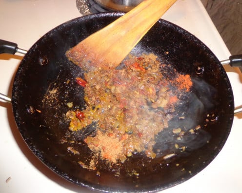 Tomatoes are added inside the pan for frying