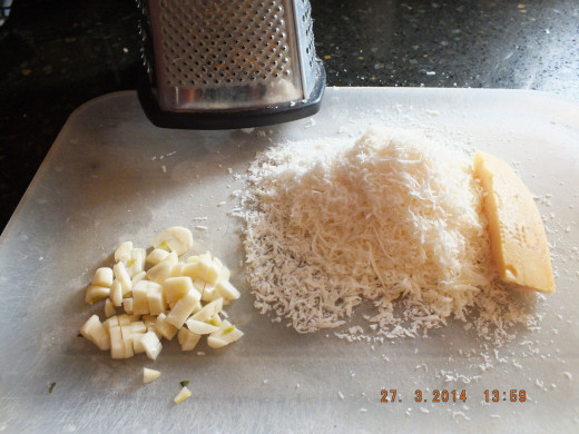 The freshly grated cheese and chopped garlic are ready for the food processor.