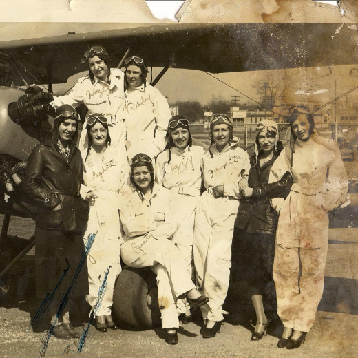 Photo from an album of my grandmother's belongings. The women of the Squadron of Death, taken in the early 30s in Akron, Ohio. My grandmother, Jessie "Rusty" Budrick, aged 20-21, is the one seated on the airplane wheel. Photo from an album of my grandmother's belongings. The women of the Squadron of Death, taken in the early 30s in Akron, Ohio. My grandmother, Jessie "Rusty" Budrick, aged 20-21, is the one seated on the airplane wheel.