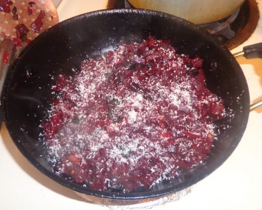 Grated coconut is added on top of the beetroot poriyal 