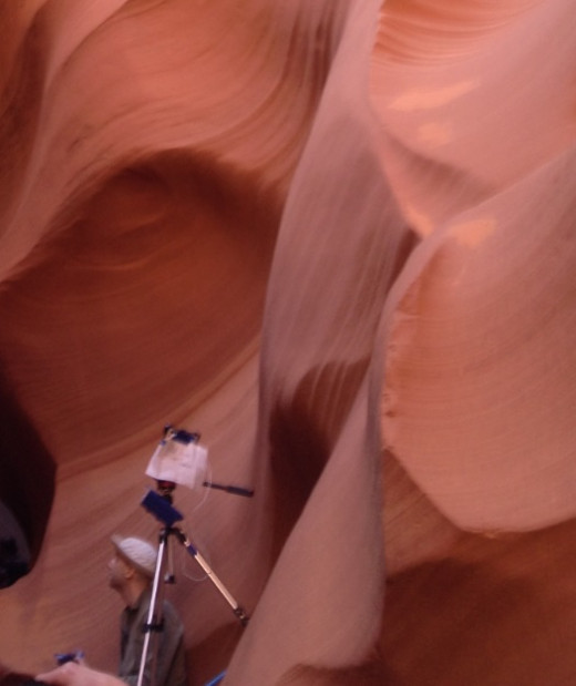 Professional Photographer with a $50 photo pass, tripod and camera taking serious photos inside Lower Antelope Canyon